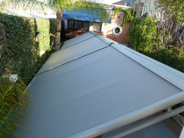 A white awning is covering the roof of a building