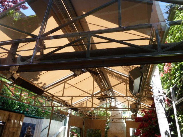 The inside of a building with a canopy and a ceiling fan