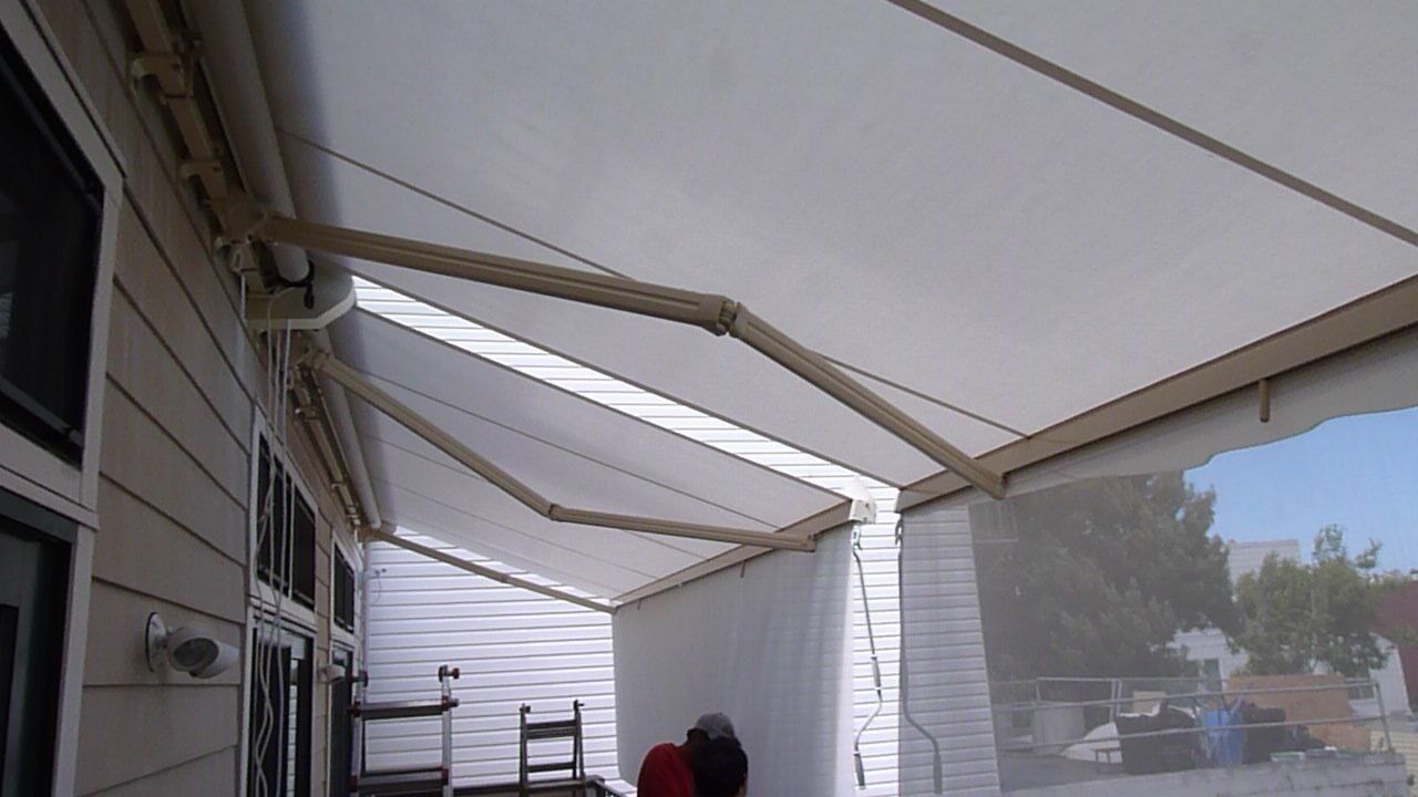 A white awning is covering the side of a house.