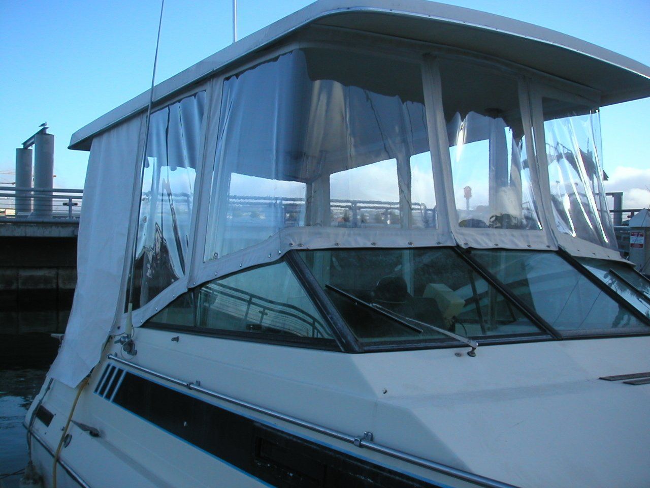 A white boat with a clear canopy on top of it