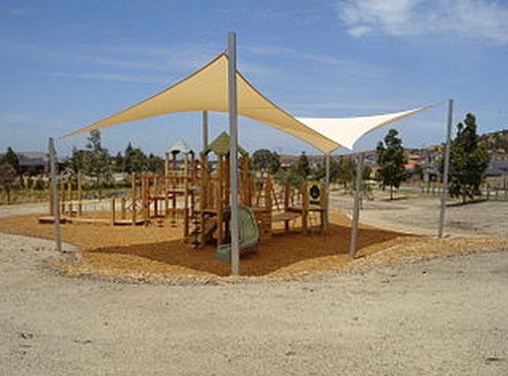 A playground with a canopy over it and a slide