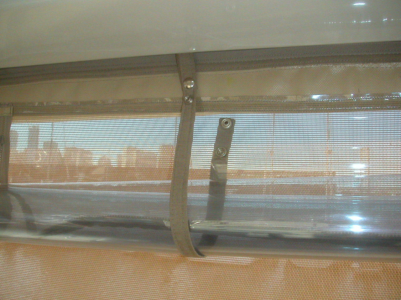A close up of a clear plastic blind on a window