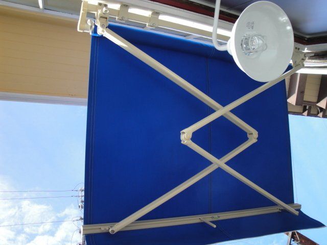 A blue awning with a light attached to it