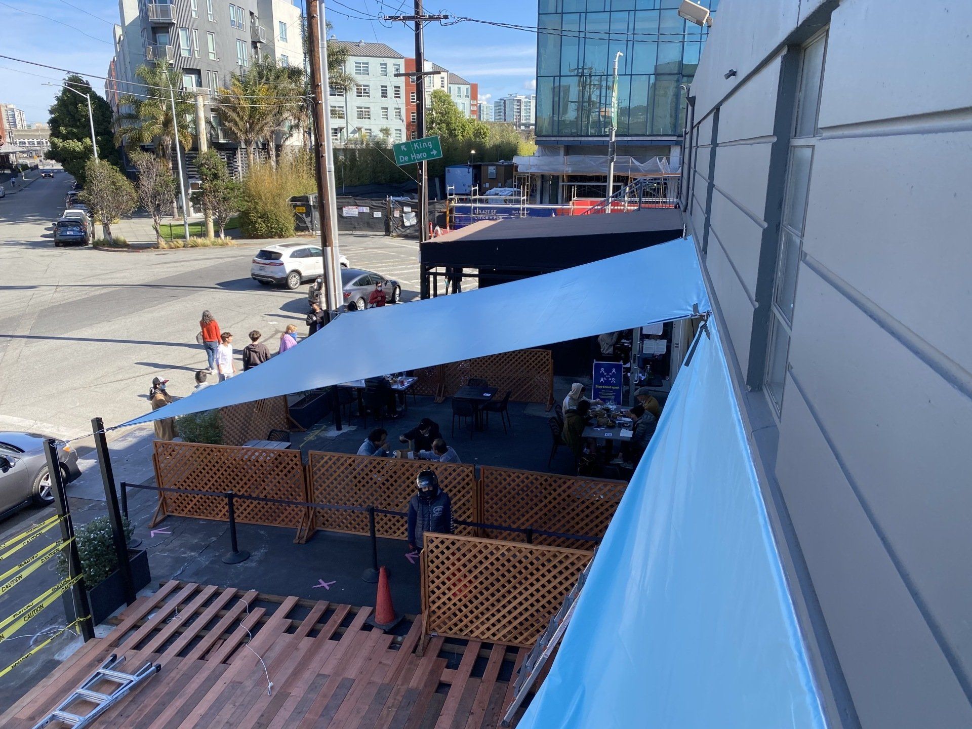 A blue umbrella is sitting on top of a wooden deck.
