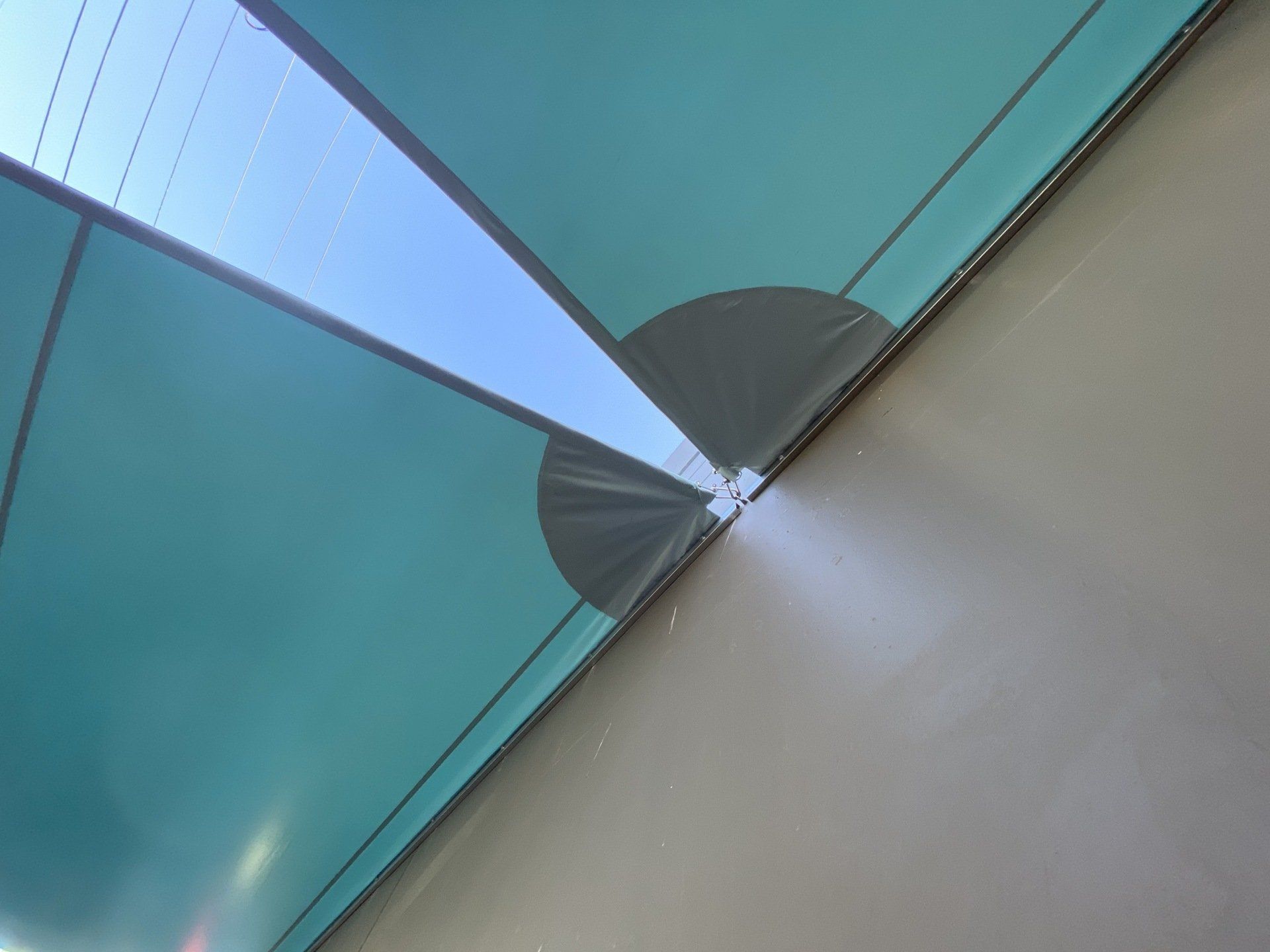 A blue umbrella is hanging from the ceiling of a building