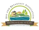 Michigan Lake to Lake Bed and Breakfast Association logo: a lake and house scene within a green circle.