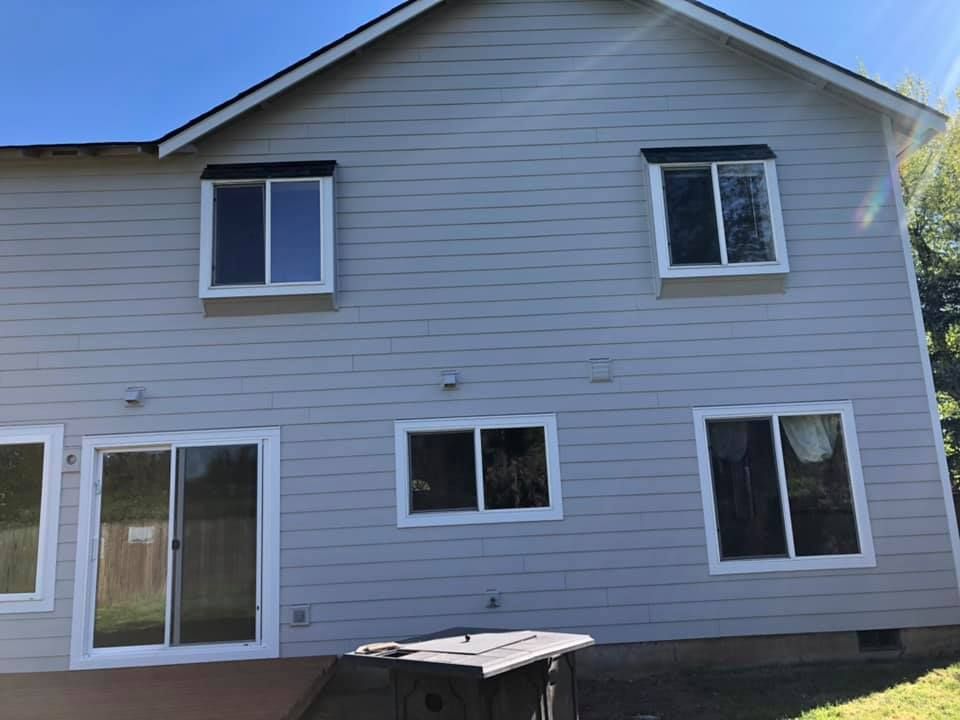 The back of a white house with a lot of windows