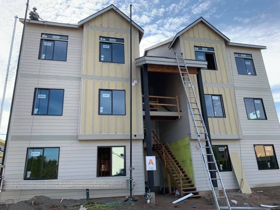 A large building under construction with a ladder on the side of it.