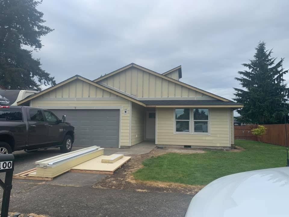 A truck is parked in front of a house that is being remodeled.