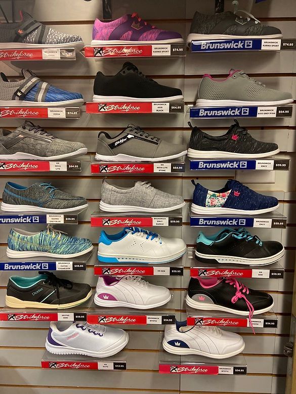 A wall filled with lots of different types of bowling shoes.