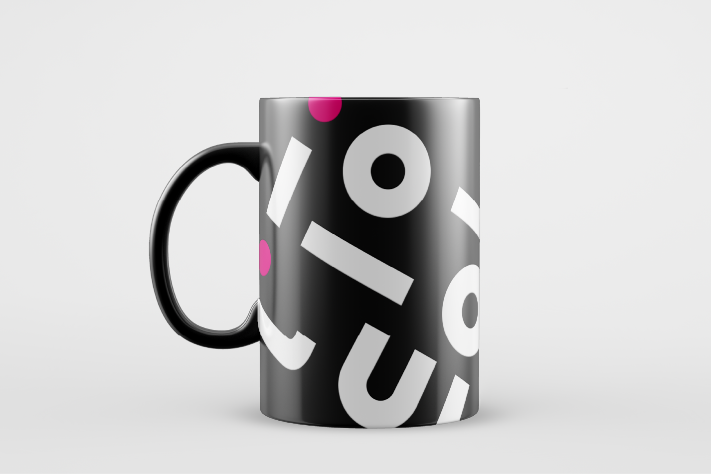 Black mug with white geometric design and pink accents.