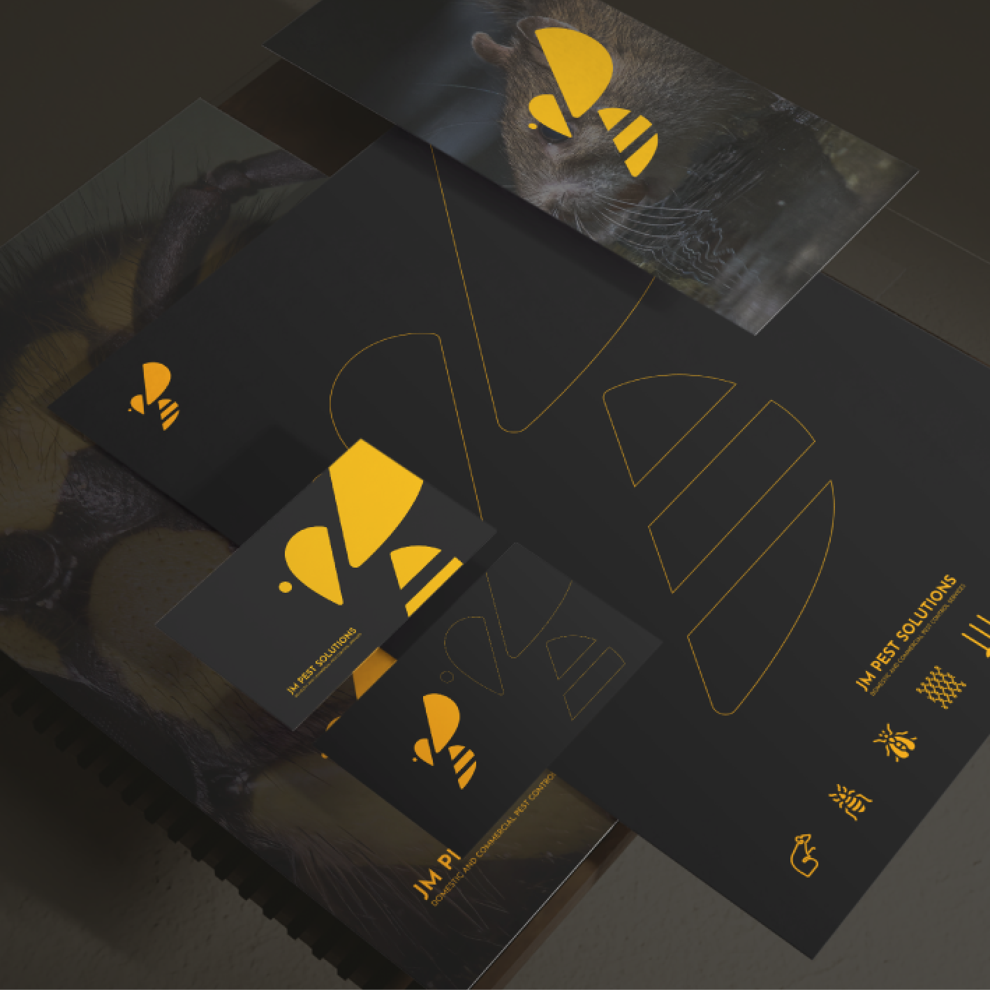 Black stationery with gold bee logo and