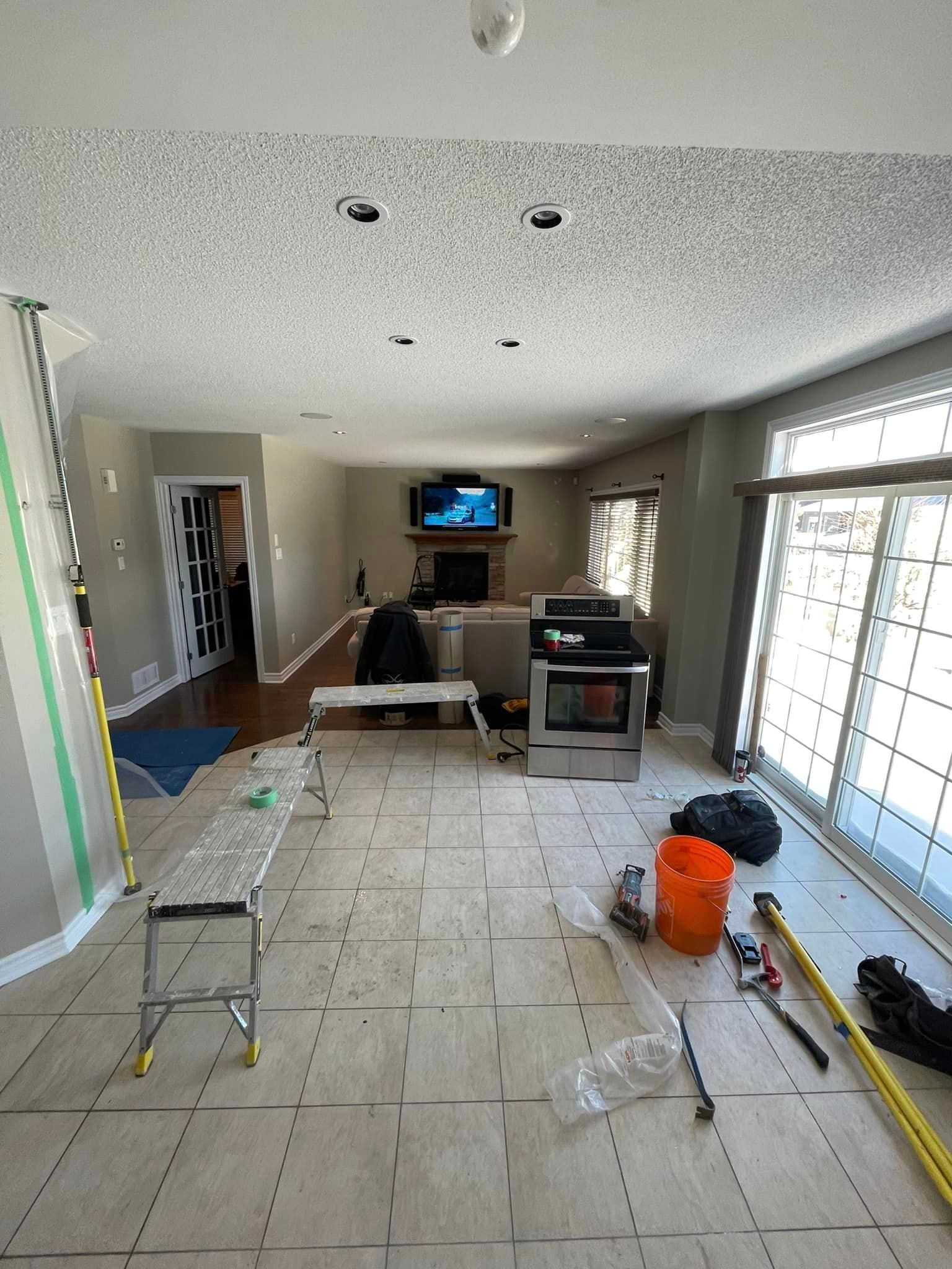 A person is holding a swatch of wood and a drawing of a room.