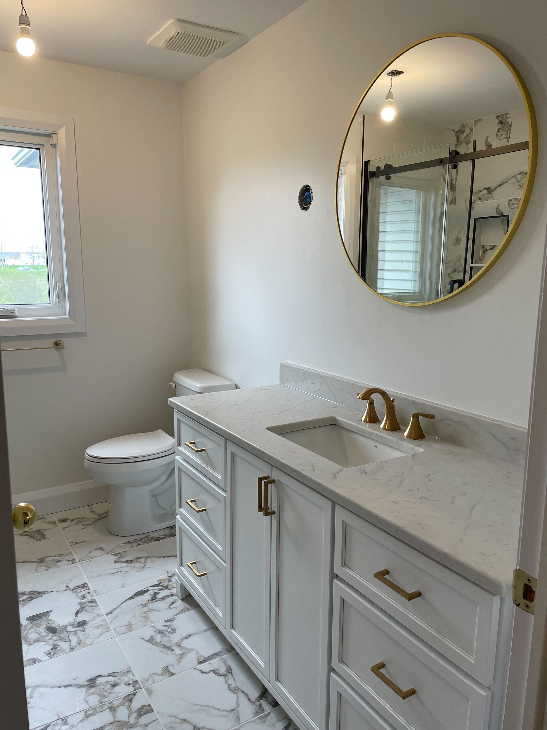 A bathroom with a sink , toilet and mirror