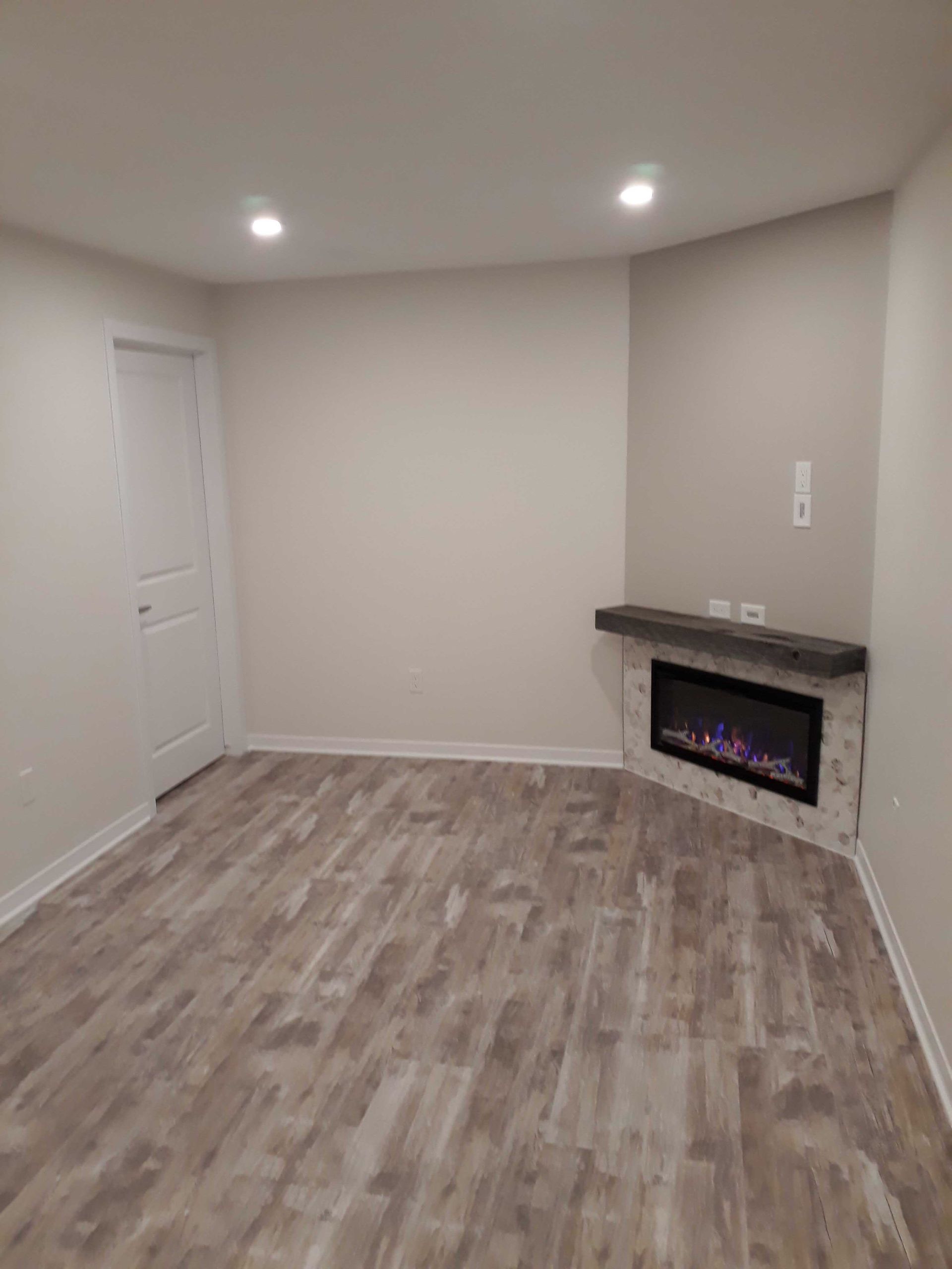 There is a fireplace in the corner of the room.