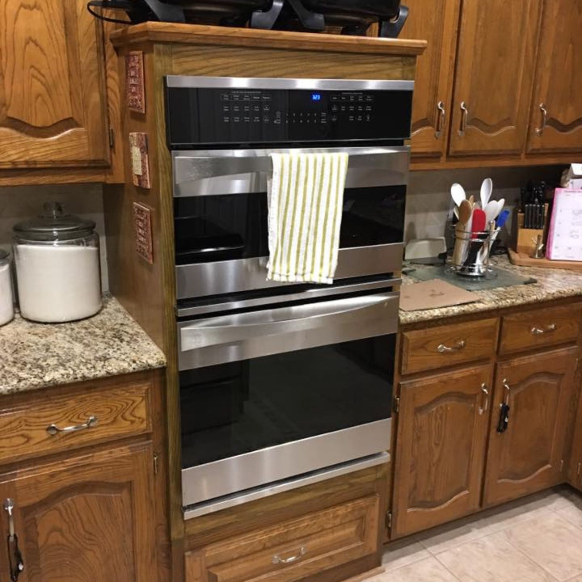 Masters Touch Roofing - A kitchen with stainless steel appliances and wood cabinets