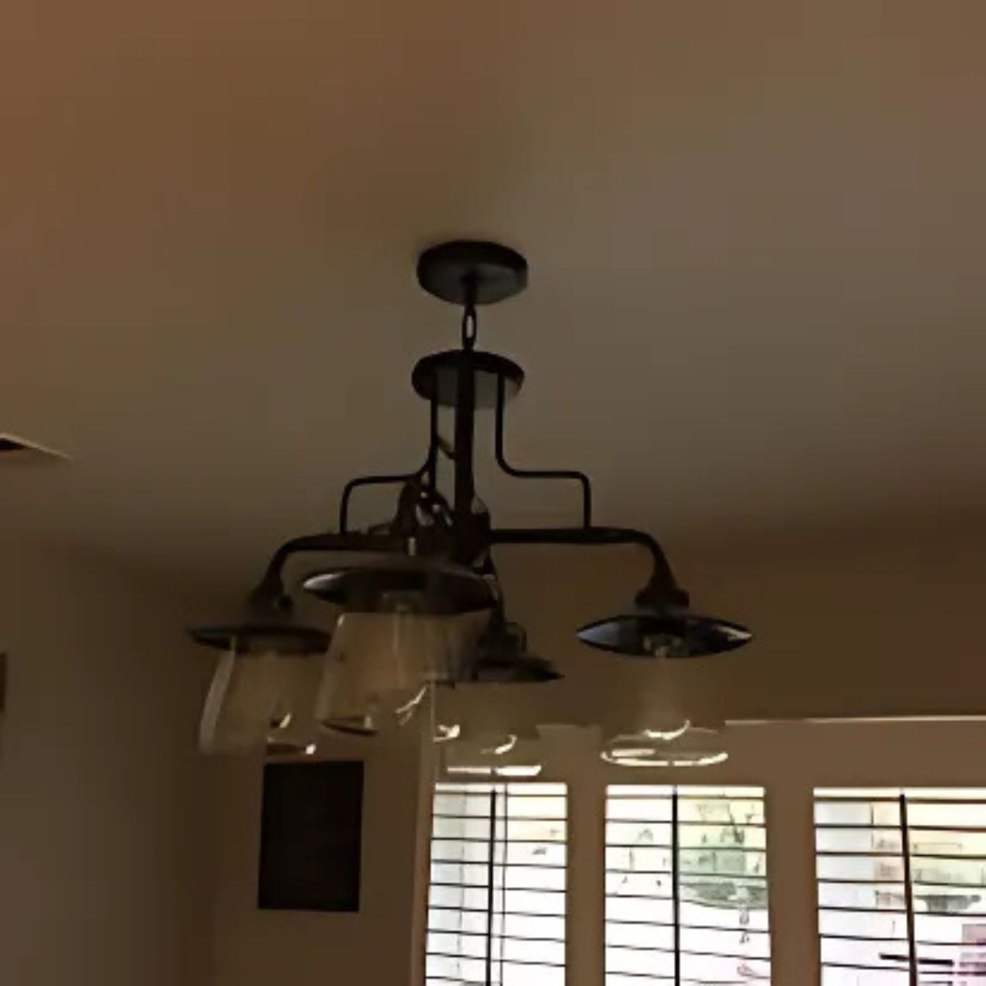 Masters Touch Roofing - A chandelier is hanging from the ceiling in a room with shutters
