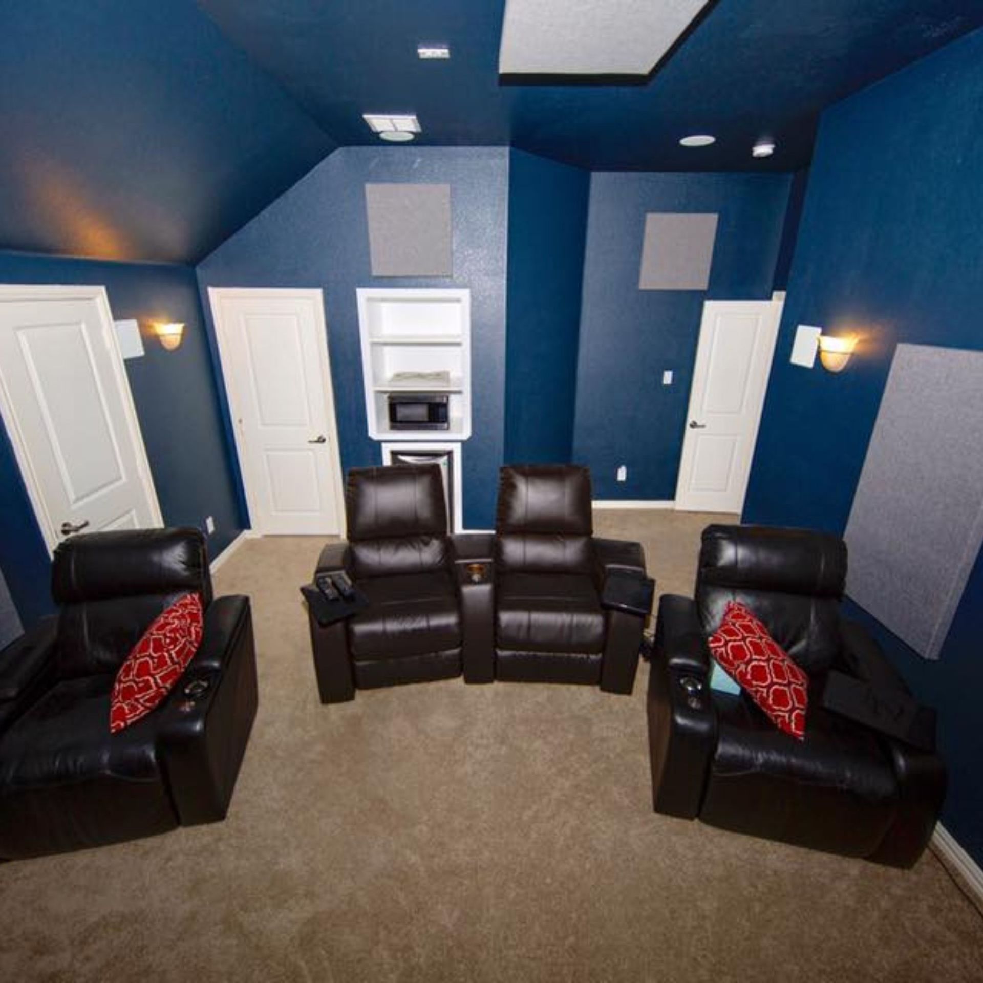 Masters Touch Roofing - A living room with blue walls and black leather chairs