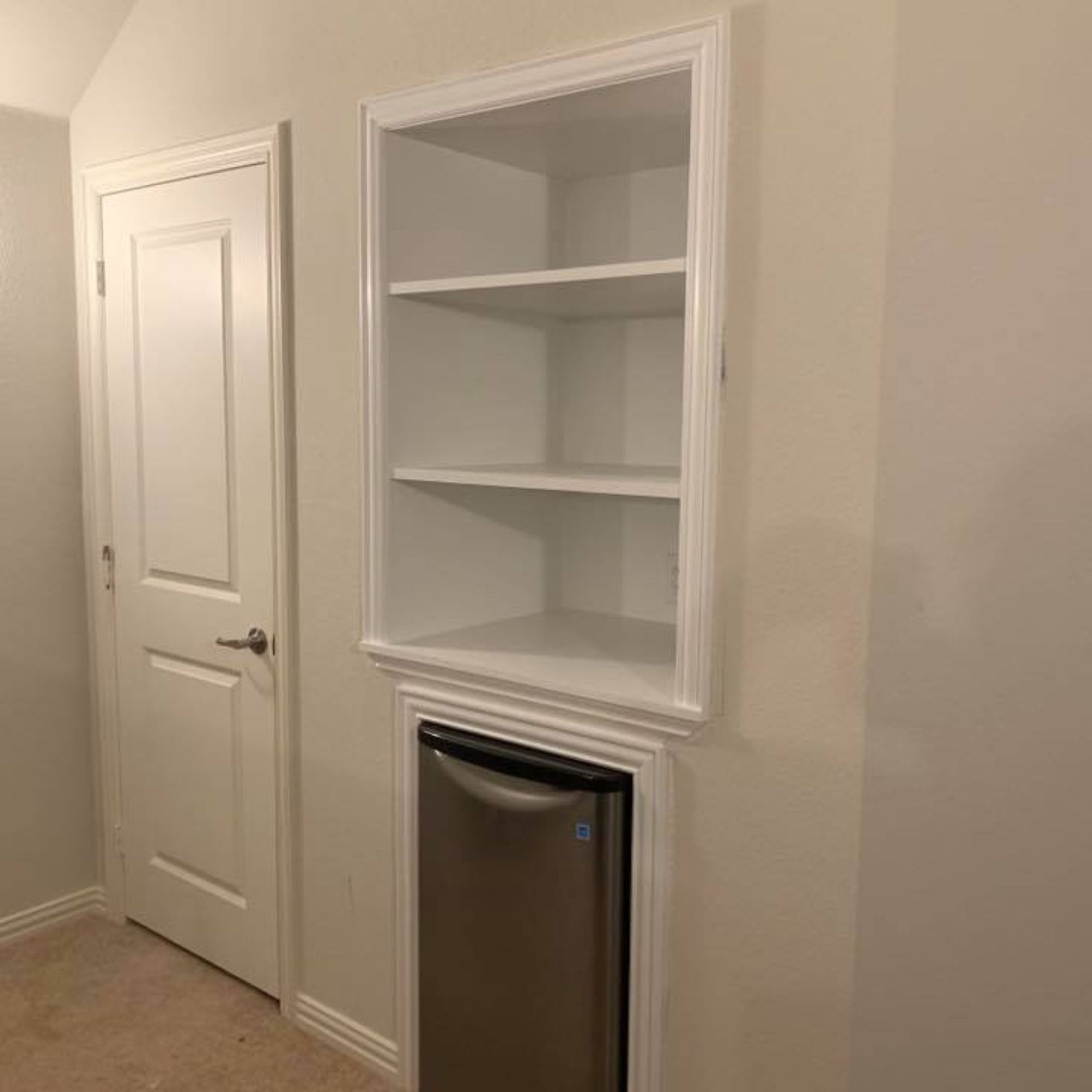 Masters Touch Roofing - There is a stainless steel refrigerator in the corner of the room.