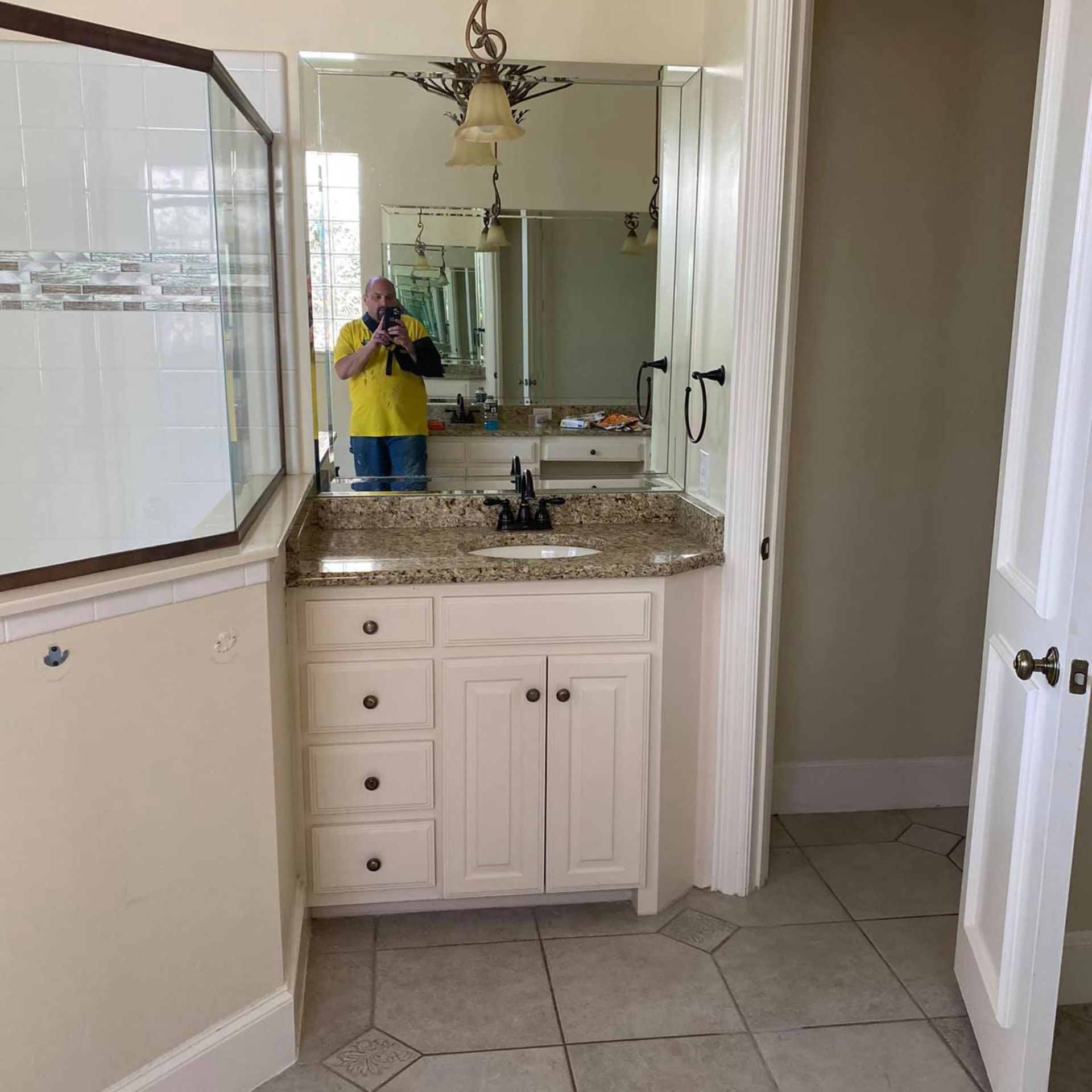 Masters Touch Roofing - A man is taking a picture of himself in a bathroom mirror.