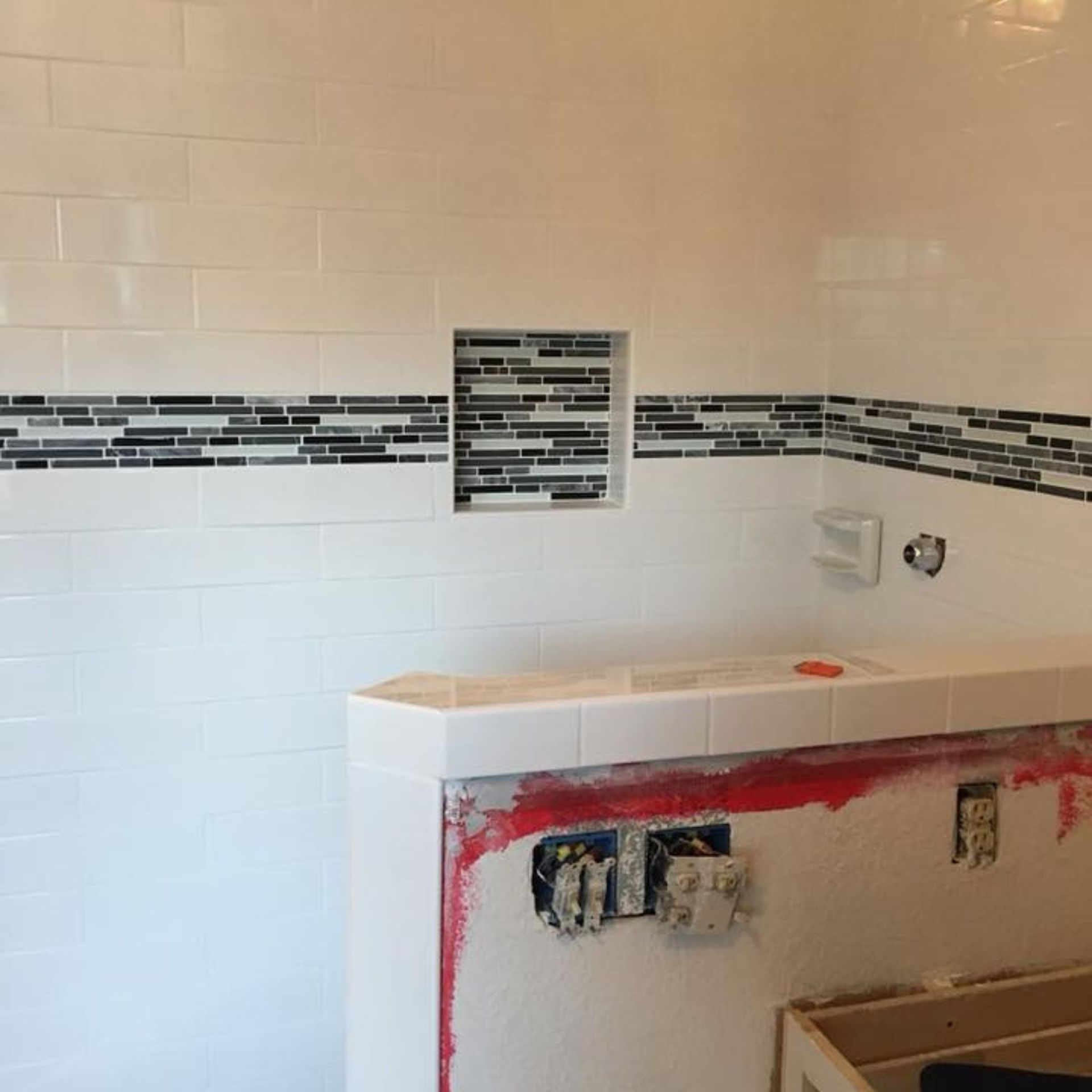 Masters Touch Roofing - A bathroom with white tiles and a sink in it