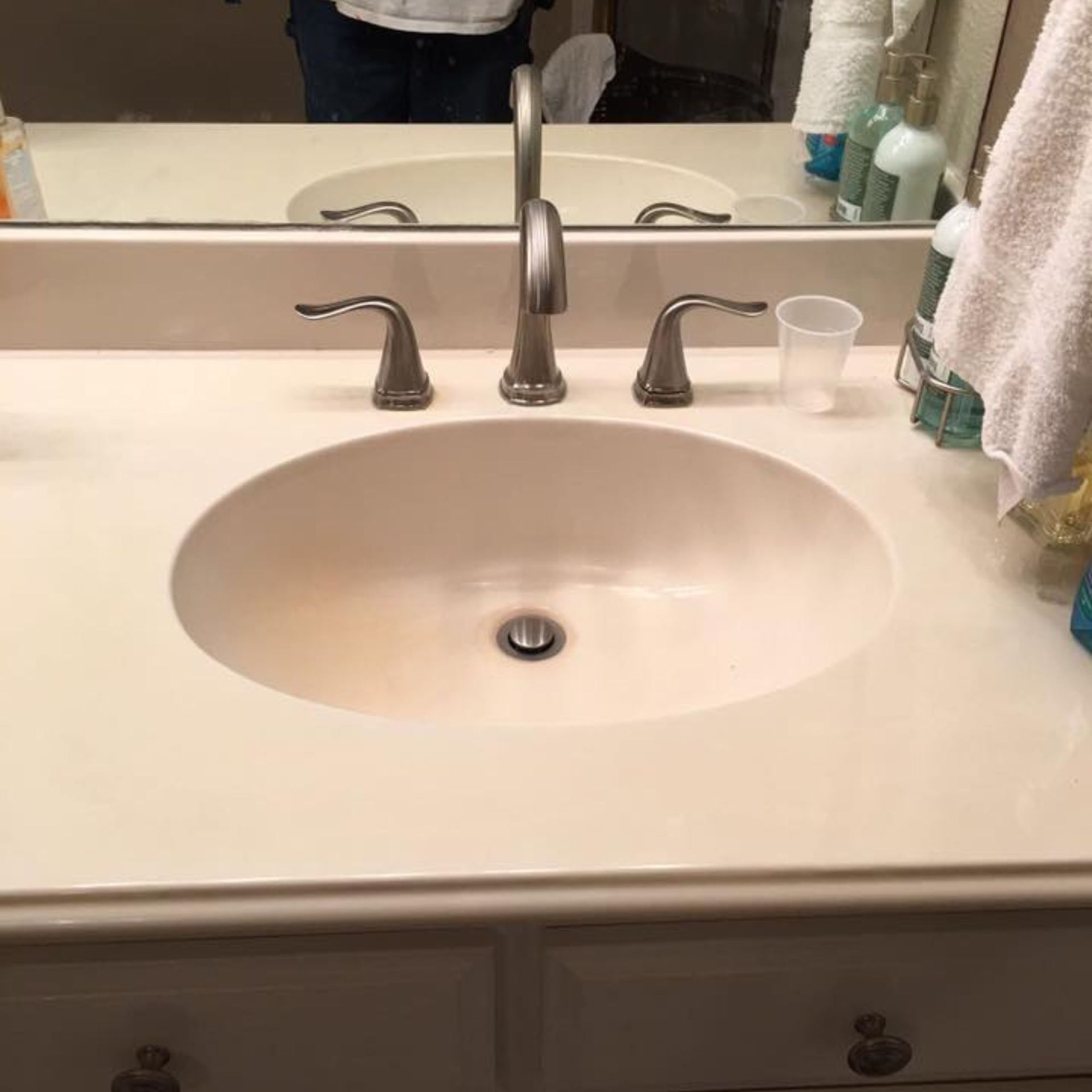 Masters Touch Roofing - A bathroom sink with a faucet and a mirror