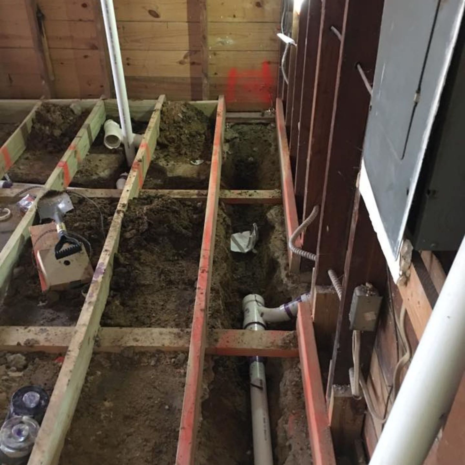 Masters Touch Roofing - A drain pipe is being installed under a wooden floor