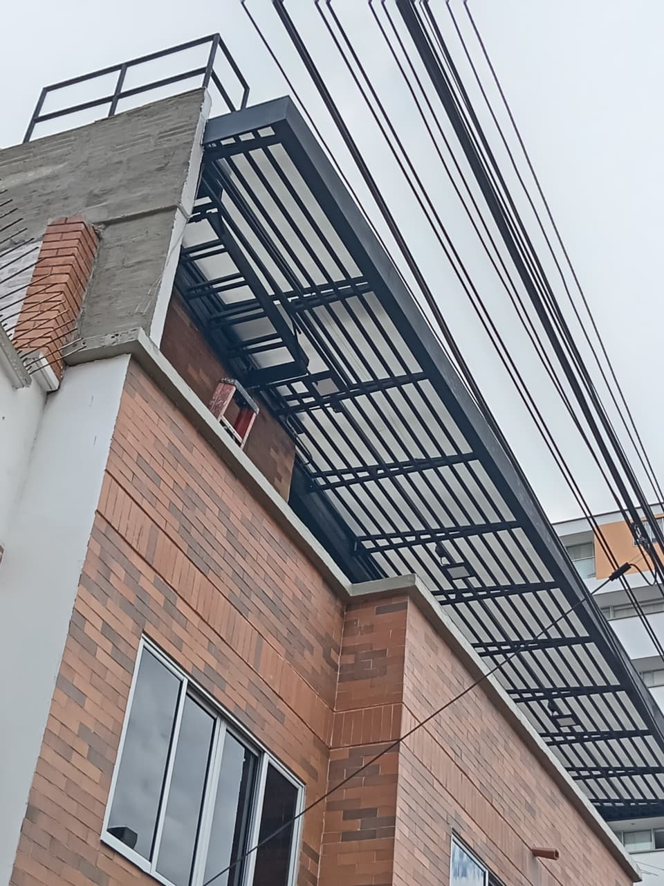 Un edificio de ladrillo con una escalera de incendios en la parte superior.