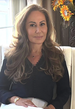 A woman wearing a black scrub top with a stethoscope around her neck