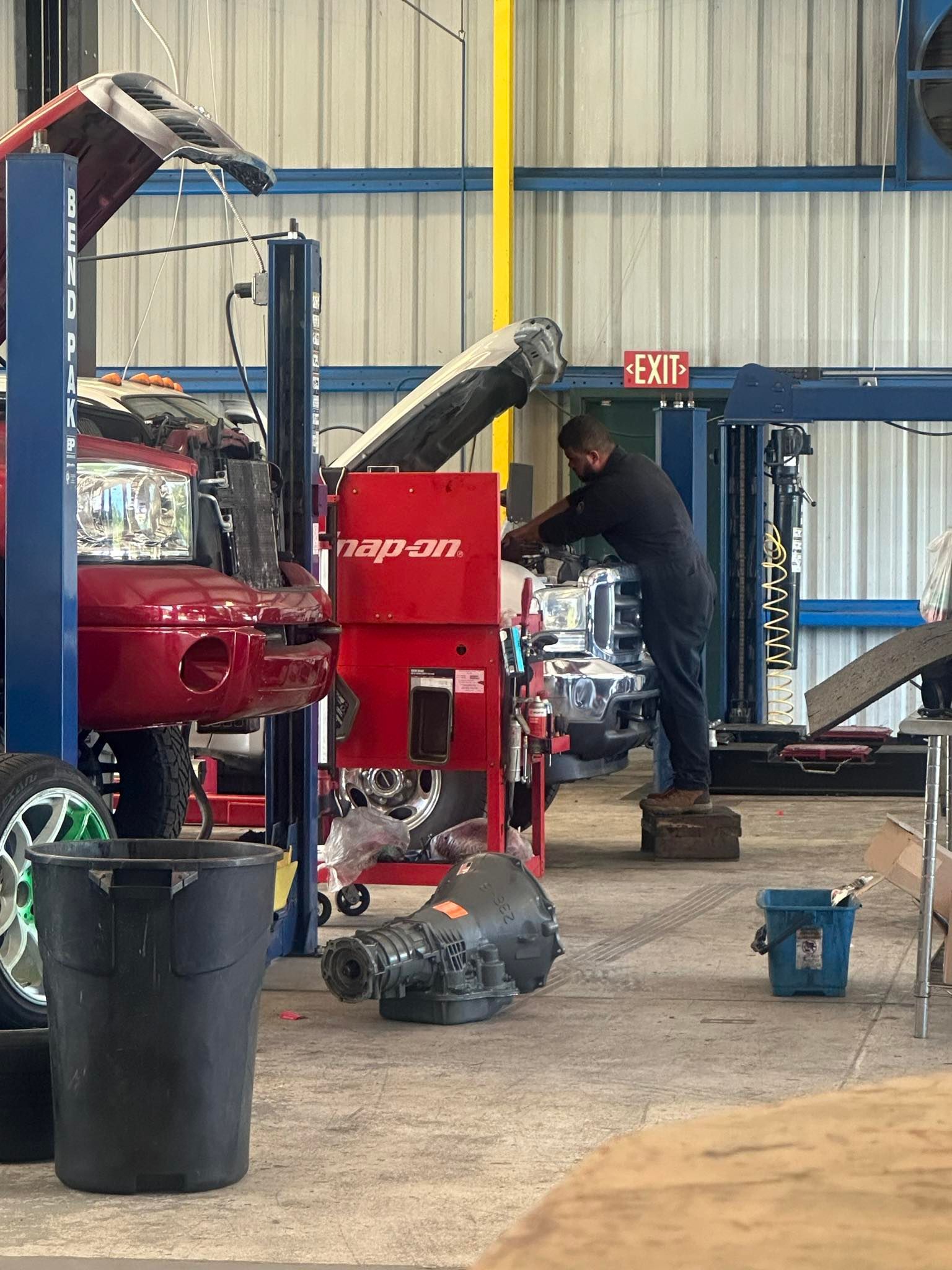 Mechanic works on a red car | Big 3 Diesel & Automotive Repair