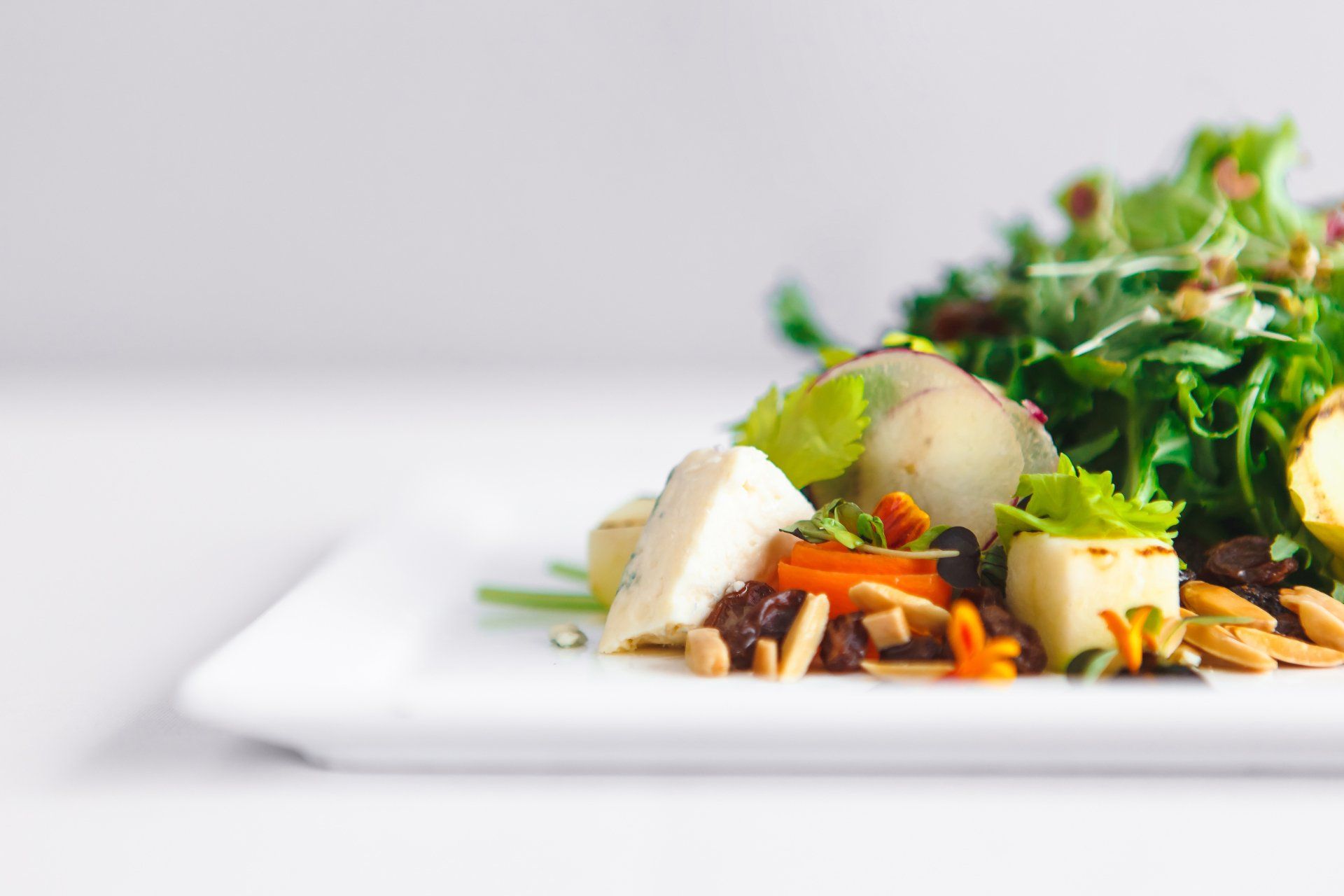 A close up of a salad on a white plate