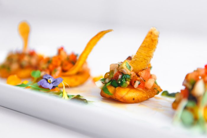 A close up of a plate of food with a flower on it.