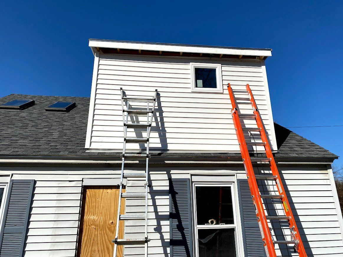 A ladder is leaning against the side of a house
