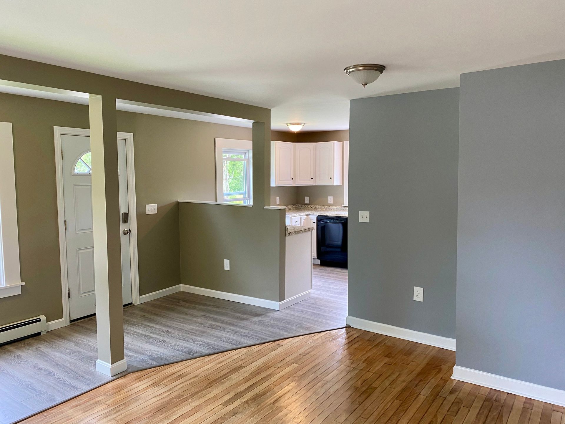 A living room with hardwood floors and gray walls