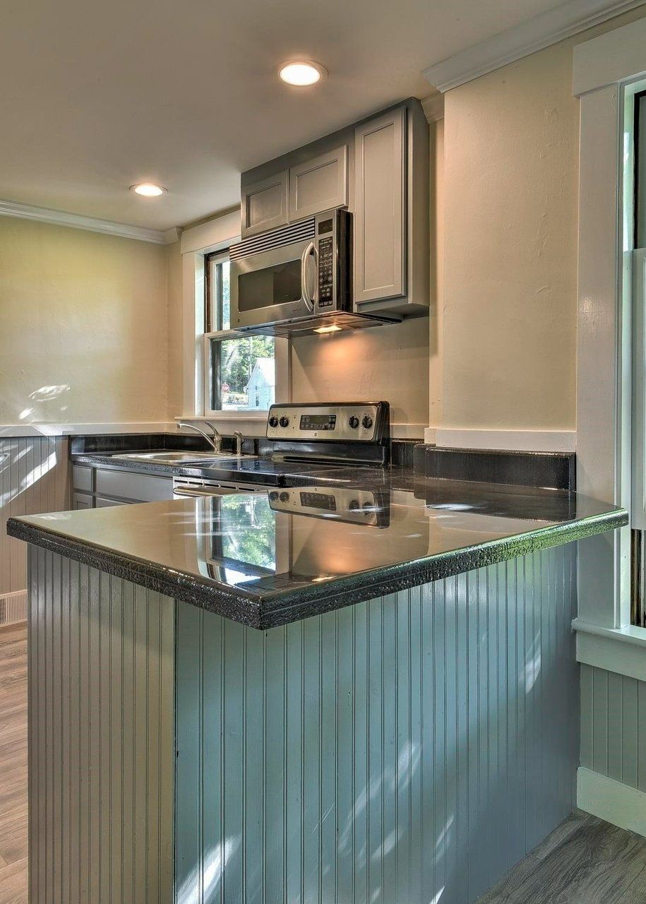 A kitchen with stainless steel appliances and a metal island