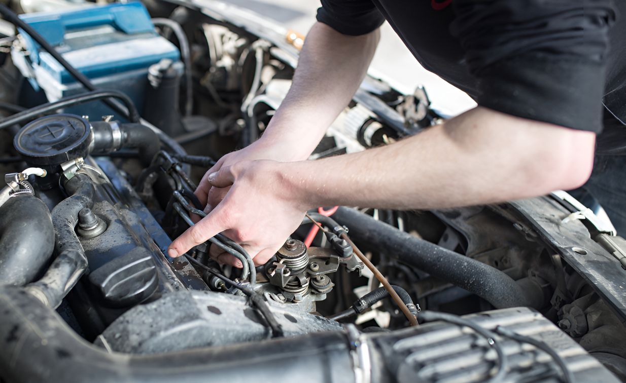 A Man is Working on the Engine of a Car — Unified Mechanical – Mobile Mechanic In Goonellabah, NSW