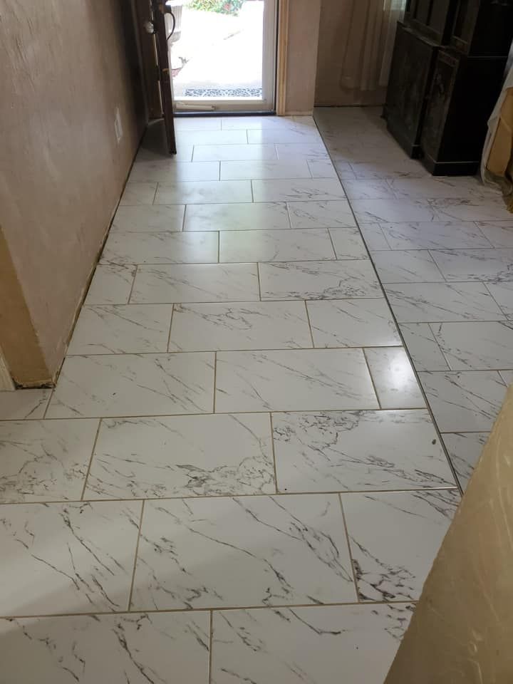 Wooden floor with a decorative gold and white tile inlay.