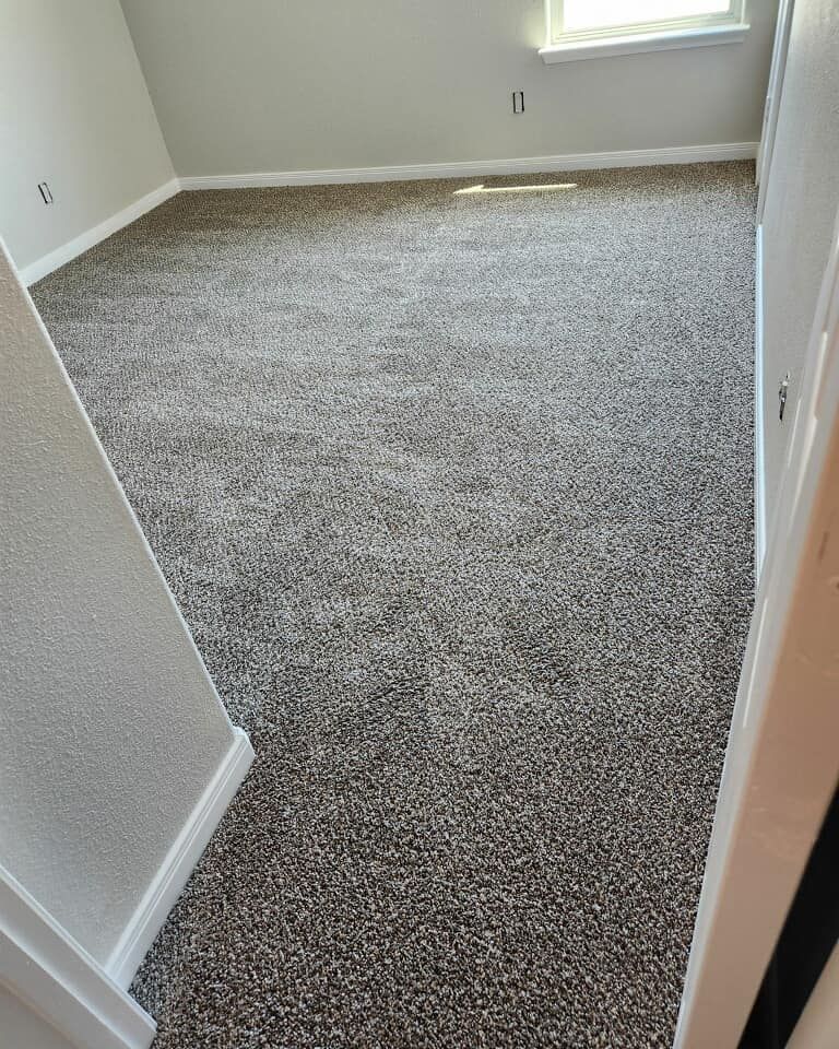 Room with new brown carpet; white trim and walls.
