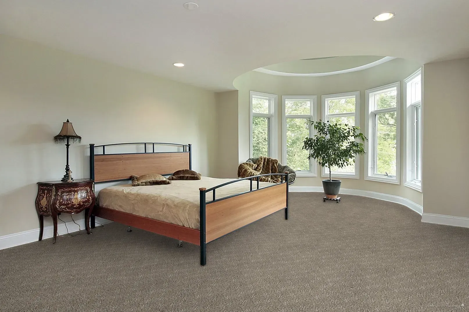 Spacious kitchen with wood floors, dark cabinets, long table with chairs.