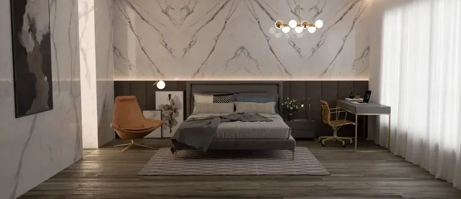 Luxurious bedroom with marble walls, bed, desk, and accent chair.