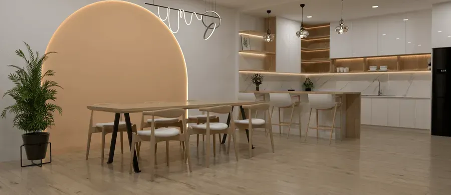 A dining room with a table and chairs, a large peach-colored wall, and a modern kitchen.