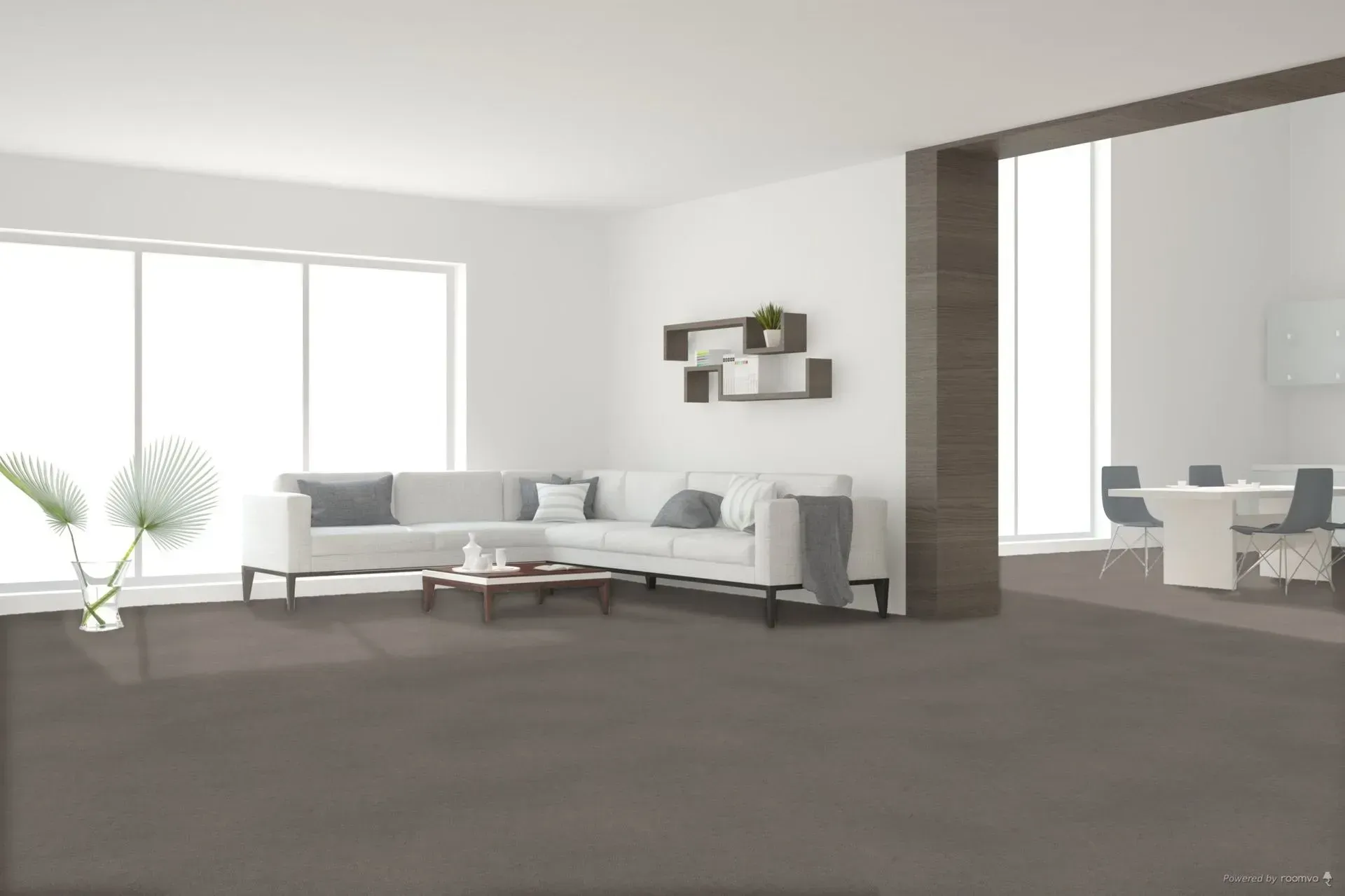 Modern living room with a sectional sofa, open to a dining area, gray carpet.