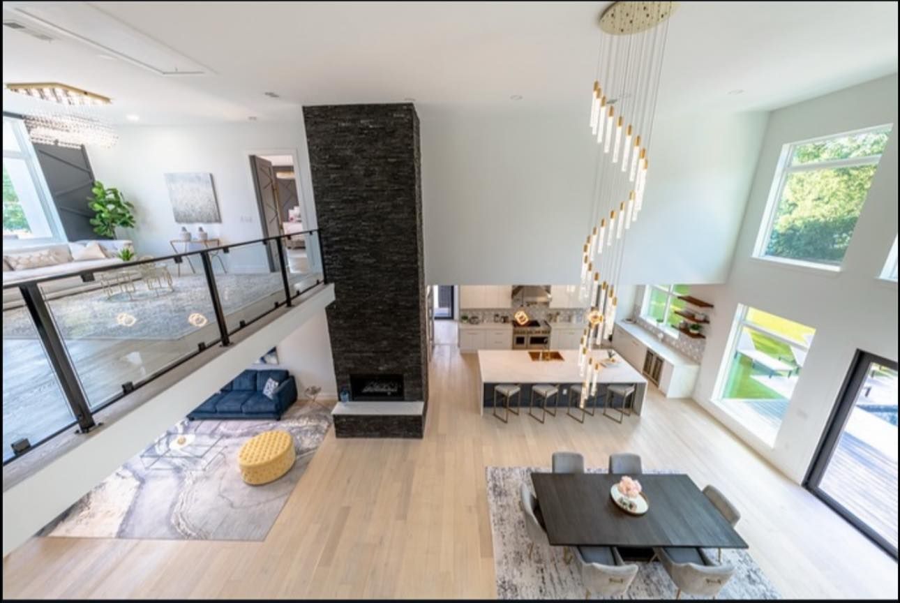 High-angle view of a modern, open-plan living space with two stories.