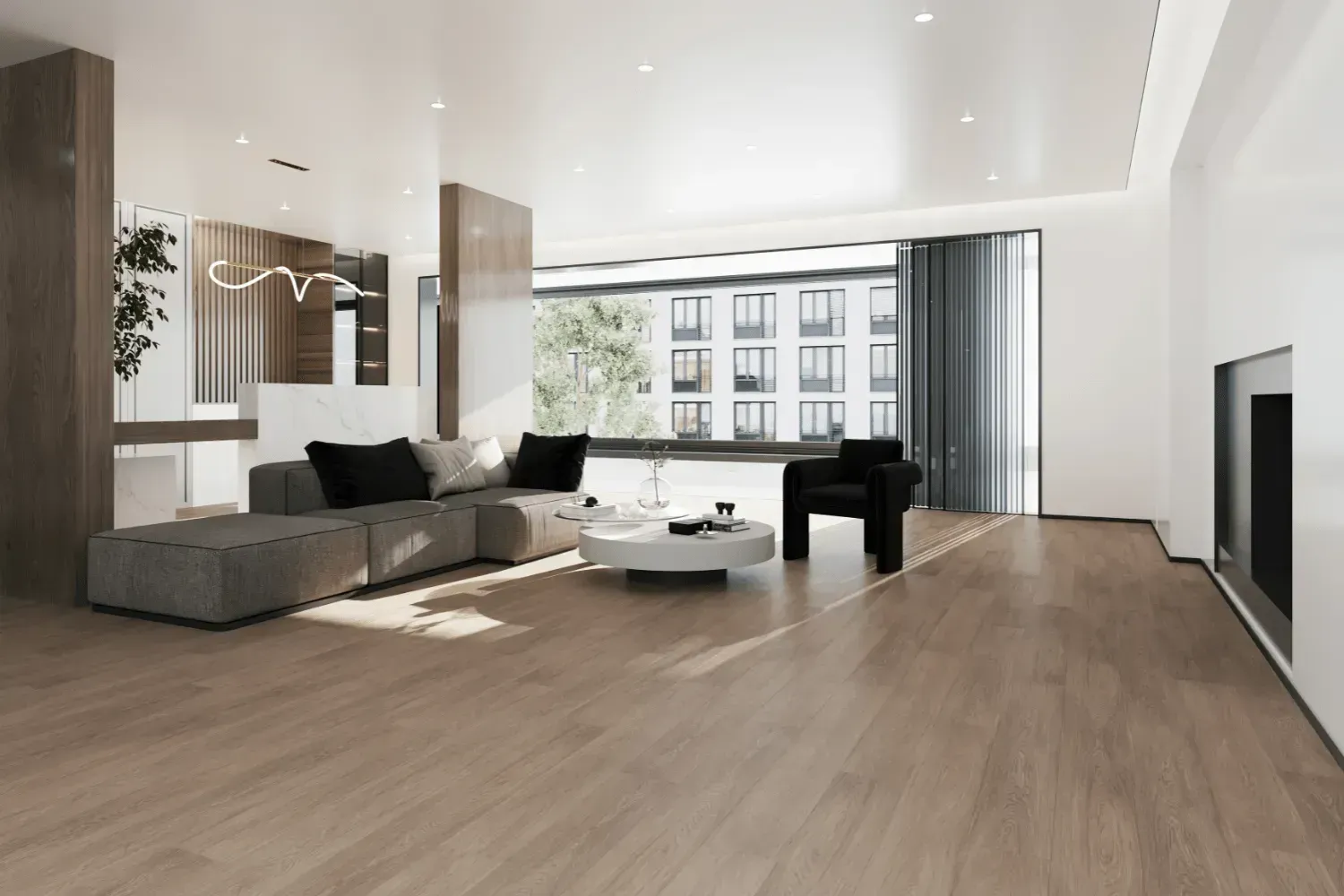 Modern living room with gray sectional, black armchair, and large windows.