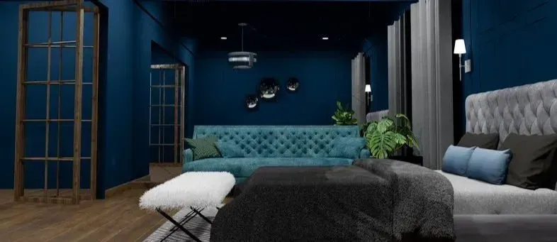 Bedroom with blue walls, tufted teal sofa, and a gray bed.