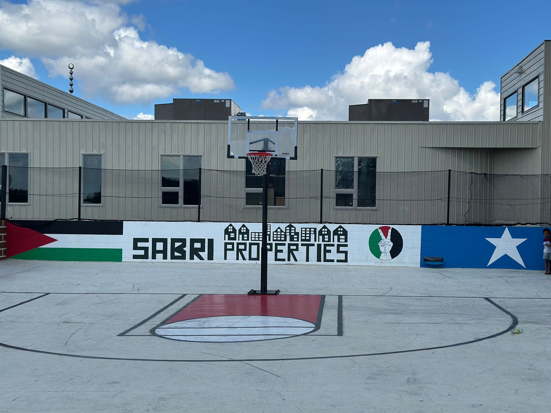 Basketball court with Palestinian and Somali flags painted on the walls.