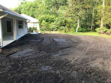 There is a lot of dirt in the backyard of a house.