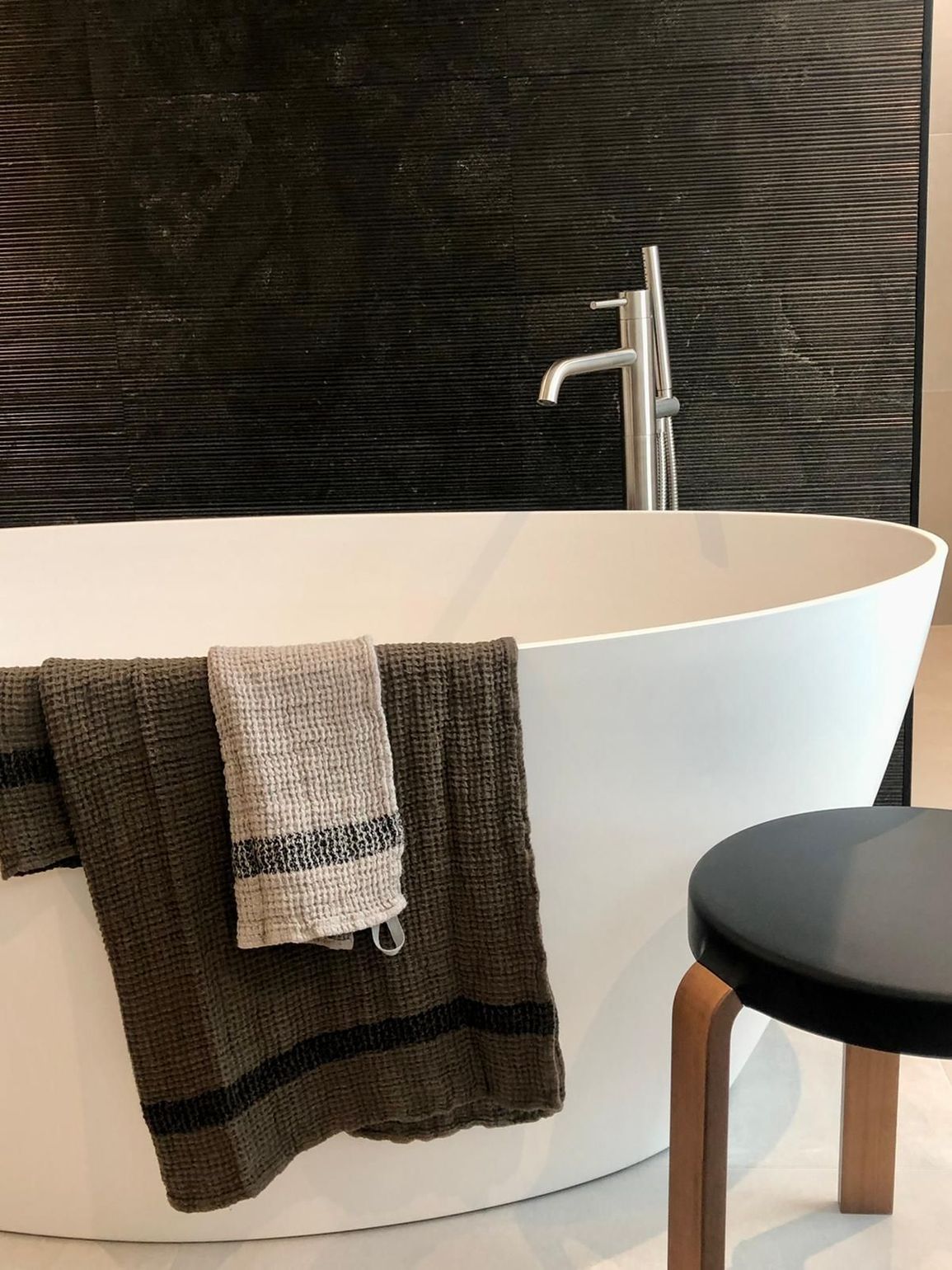 Une baignoire dans une salle de bain avec deux serviettes dessus