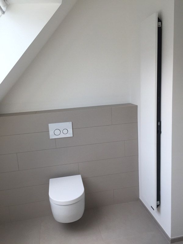 Une salle de bain avec toilettes et radiateur mural