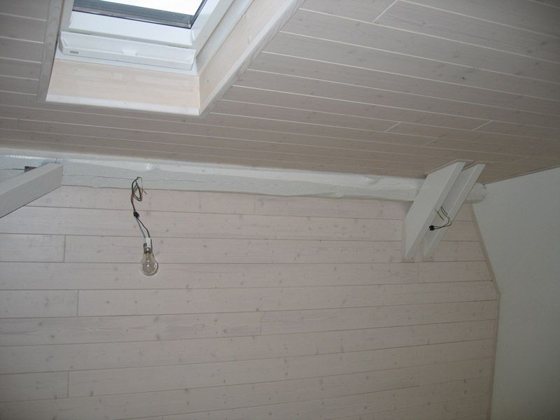 Un plafond avec une lucarne et une lumière suspendue